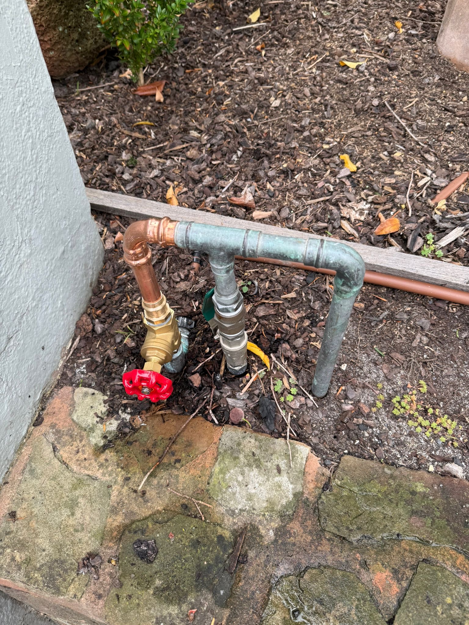 Old galvanised pipe with red gate valve replaced with new copper pipe Northcote Melbourne